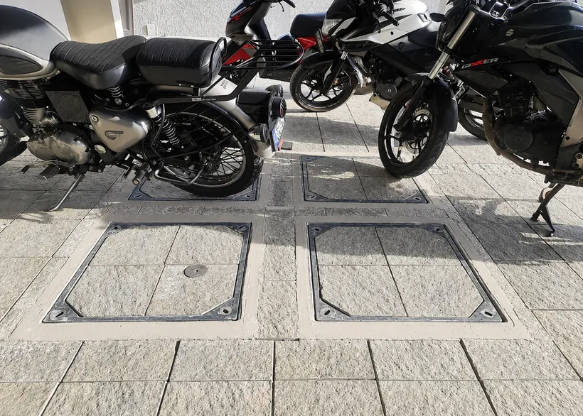 Granite-filled recess covers in a parking bay