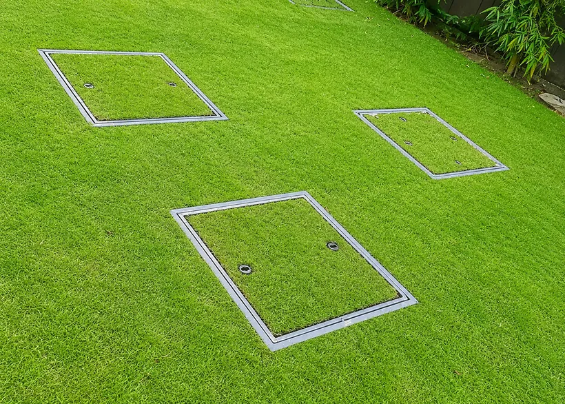 Grass-filled recess covers in a lawn