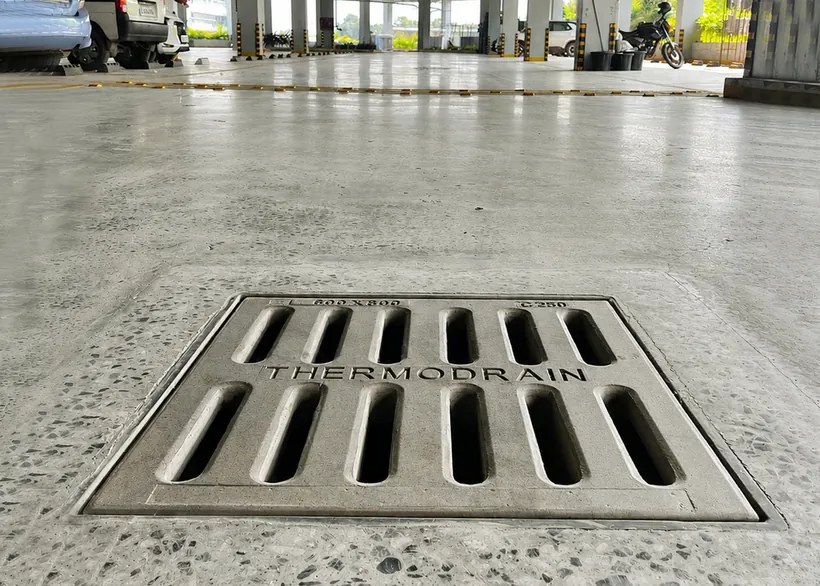 Slotted water gully cover in a parking bay